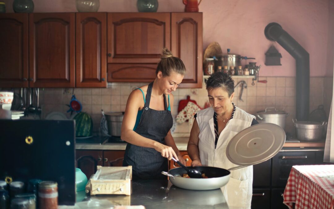cheerful women cooking together in kitchen